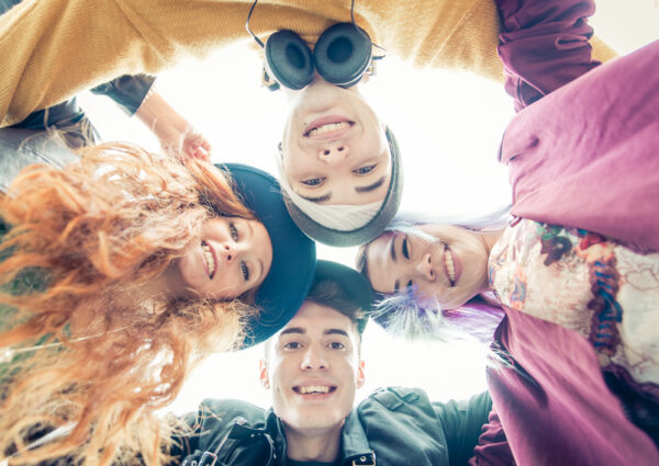 Teens portrait. group of teens hugging together and sharing good mood